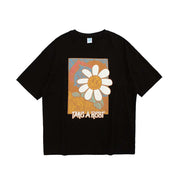 T-Shirt mit farbigem Kunstwerk und Gänseblümchen-Motiv
