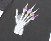 Camiseta con mano de calavera y anillos cuádruples